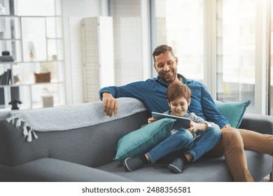 Man, smile and son with tablet on sofa for online gaming, entertainment and streaming together. Family, home and child with tech by father for network, connection or bonding on weekend in living room - Powered by Shutterstock