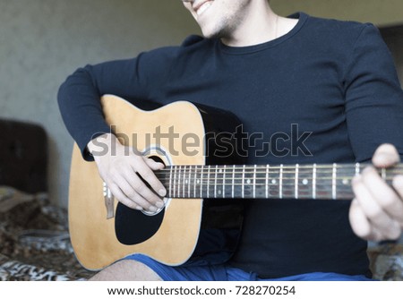 Similar – Young Boy Enjoying Music Playing Guitar Outdoors