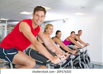 Man Smiling At Camera During Spin Class At The Gym