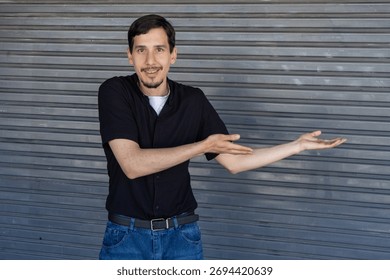 Man smiling and gesturing, presenting empty space