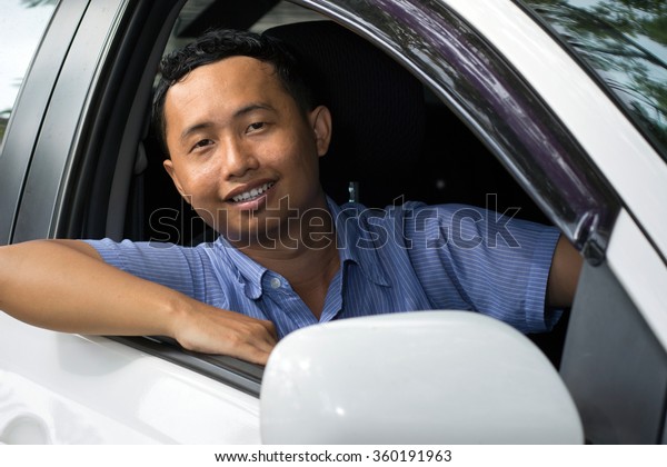 Man smiling Greet on car

