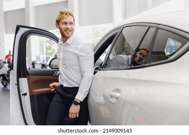 Man Smiling Satisfied Fun Customer Male Buyer Client Wear White Shirt Get Out Car Touch Door Choose Auto Want Buy New Automobile In Showroom Vehicle Dealership Store Motor Show Indoor Sales Concept