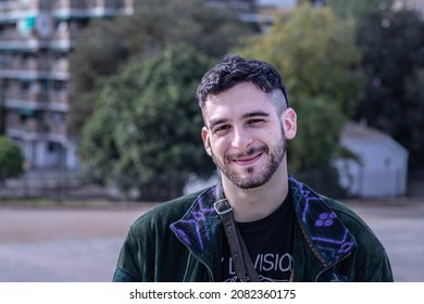 Man Smiling While Looking At Camera With Slanted Eyes