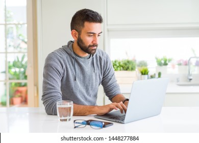 Man smiling working using computer laptop - Shutterstock ID 1448277884