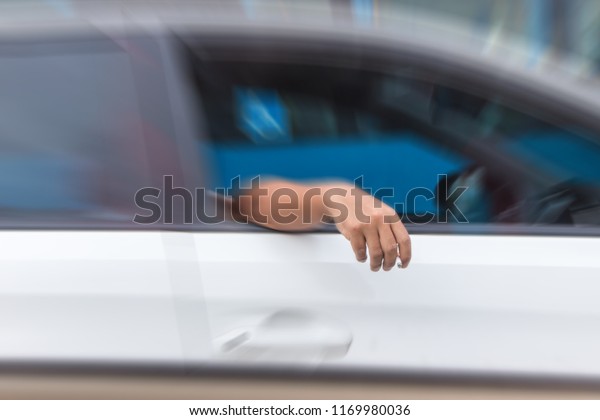 Man smoke while\
driving on the street.