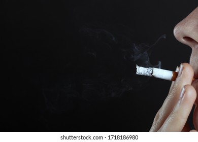 Man Smokes A Cigarette On A Dark Background Close-up Copy Space, Health Hazard, Harm To The Body From Tobacco Use, Bad Habit.