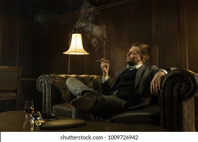 Man Is Smoking A Cigar