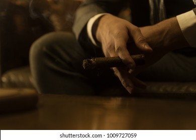 Man Is Smoking A Cigar