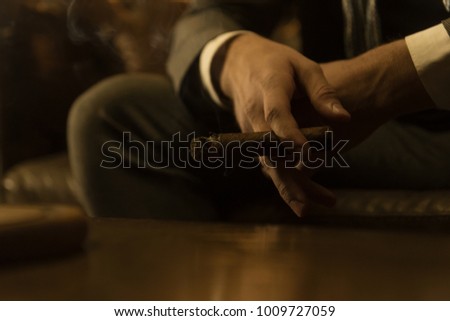 Man is smoking a cigar