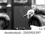 Man smoking a cigar in a lounge