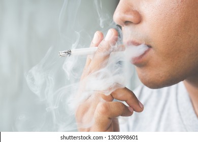 Man Smoking A Cigarette. Cigarette Smoke Spread. 