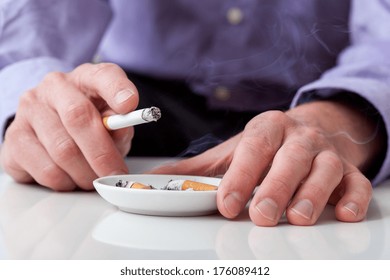 Man Smoking Cigarette And Using An Ashtray