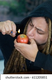 Man Smoking From Homemade Apple Bong, Drug Addiction Concept