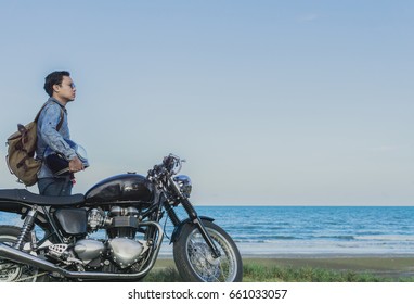 man smoking a motorcycle riding on the beach - Powered by Shutterstock