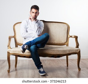 man smoking on a sofa - Shutterstock ID 373246213