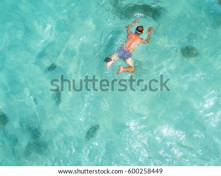 man with snorkle swimming in the sea in cleared water Stok fotoğraf © 