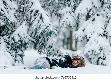 Man In Snow. Homeless Male Sleeping Outdoor Under Trees. Odd Bizarre Shocked Traveler Guy Freezing On Ground In Frost Winter Day. Unique Person Lifestyle. Overcoming Challenges. Destination Complete.