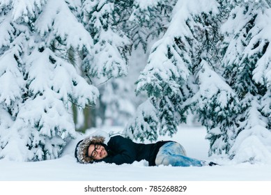 Man In Snow. Homeless Male Sleeping Outdoor Under Trees. Odd Bizarre Shocked Traveler Guy Freezing On Ground In Frost Winter Day. Unique Person Lifestyle. Overcoming Challenges. Destination Complete.