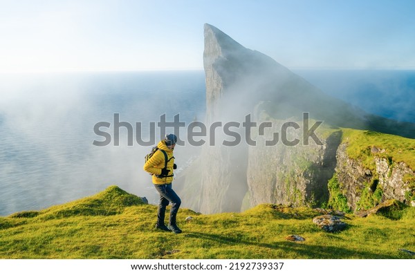Man solo\
travel backpacker hiking in scandinavian mountains active healthy\
lifestyle adventure travel vacation. Travel concept of discovering,\
learning and observing\
nature.