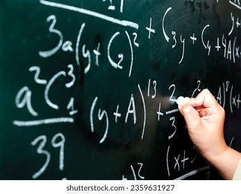 A man is solving maths problem on background with white chok by hand |Learning mathematics picture 