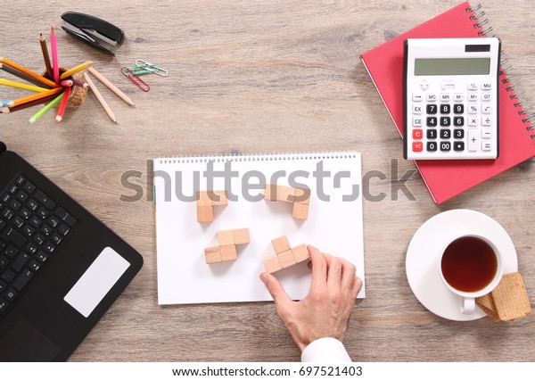 Man Solving Puzzles On Office Desk Royalty Free Stock Image