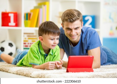 man and son kid playing with tablet computer