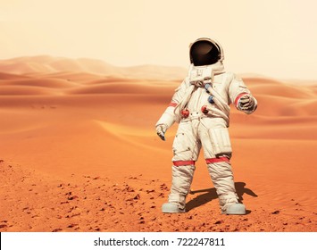 Man In A Space Suit Standing On The Red Planet Mars. Spaceman Conquer A New Planet. Concept Of The Space 