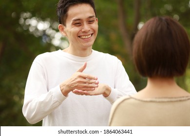 A Man Speaking In Sign Language 