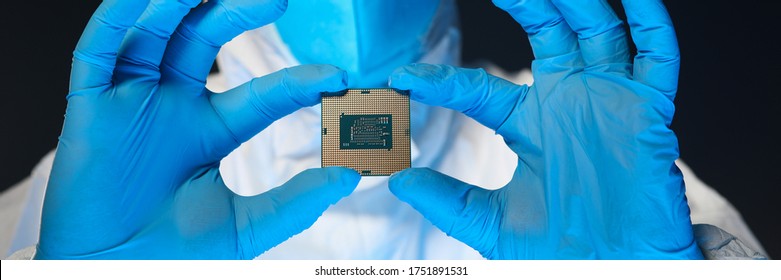 Man in special uniform shows microprocessor chip. Software-controlled device for processing information. Production technology. Development special chip. Scientist is engaged in chip implementation