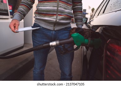 Man spend all his money on gasoline. Expensive gasoline. High petrol and fuel prices