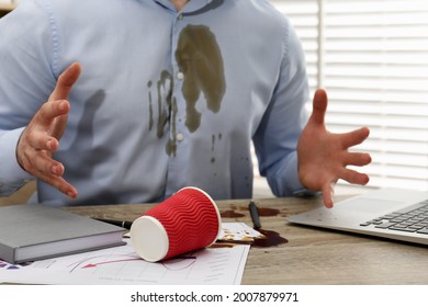 Man With Spilled Coffee Over His Workplace And Shirt, Closeup