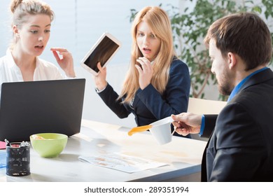 Man Spilling Tea On Documents At Work