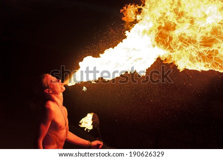 man spits fire