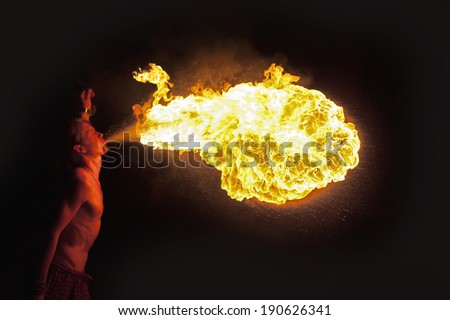 man spits fire