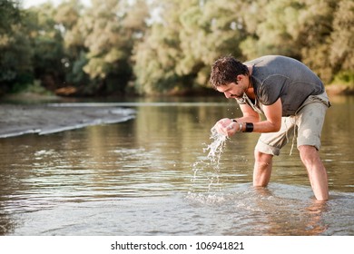 Man Splashing Water On His Face Into The River - Into The Wild Series