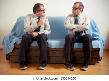 Man With Split Personality Sitting On A Couch