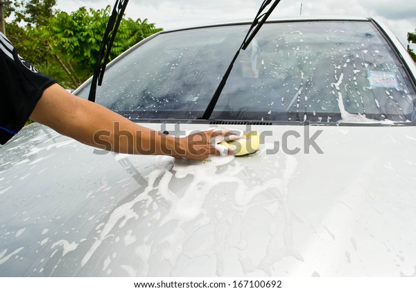 man and\
sponge for cleaning car and washing car\

