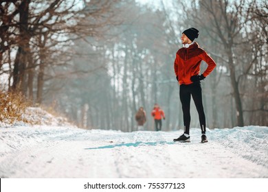 Man Sportsman Taking Break From Running in Extreme Snow Conditions - Powered by Shutterstock