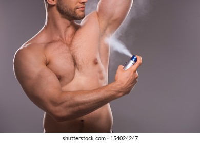 Man Spraying Deodorant