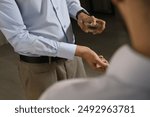 Man spraying luxury perfume near mirror indoors, closeup