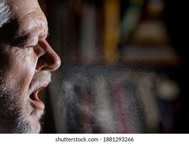 A man sprays aerosols into the air while speaking.