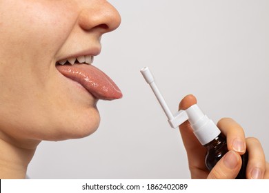 A Man Sprays A Spray Into The Oral Cavity From Candidiasis Of The Oral Mucosa. Thrush, Candida, Spray The Medicine Into The Mouth. Medications, Therapy And Treatment Of A Sick.