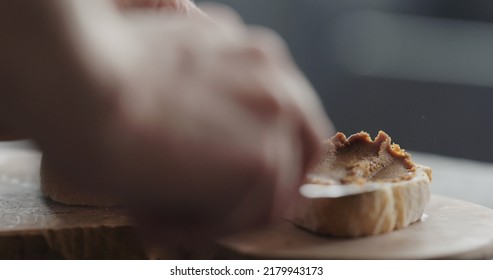 Man Spread Caramel Spread On Ciabatta Bread