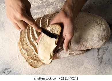 Man Spreading Cream Cheese Butter Or A Slice Of Bread Slice On Wood Board. Dieting Bread. Close-up. Healthy Nutrition Concept. 