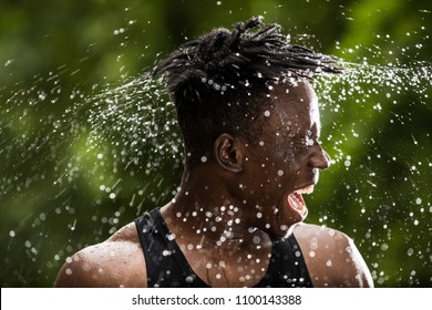 Man sprinkles water turning his face