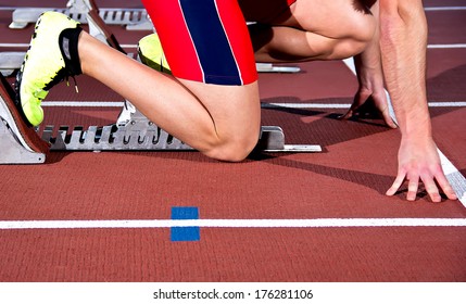 Man Sprinter Leaps From Starting Block.