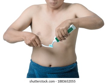 Man Squeezing Toothpaste Onto The Toothbrush.