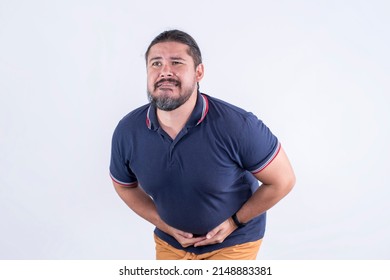 A man squirms and bends while touching his lower abdomen. Feeling sudden diarrhea or loose bowel movement.