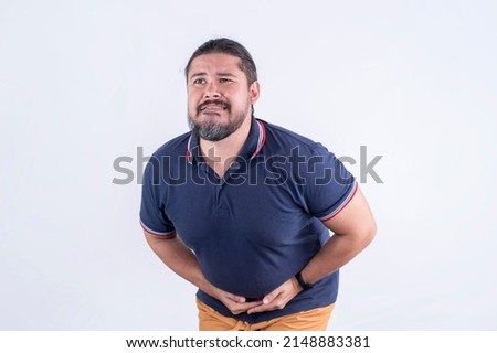 A man squirms and bends while touching his lower abdomen. Feeling sudden diarrhea or loose bowel movement.