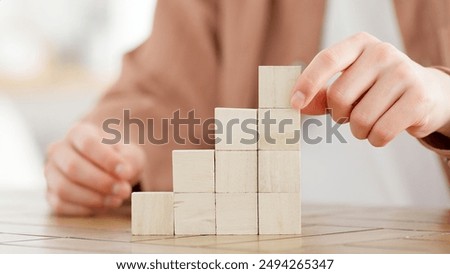 A man stacking building blocks